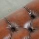 Brown cowhide Chesterfield ottoman in English style with ornate legs