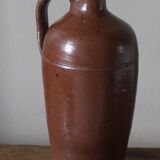 Vintage stoneware liqueur bottle with handle and spout.