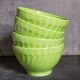 Four vintage spring green earthenware bowls