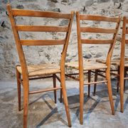 Set of 4 mid-century Italian dining chairs with woven seats, circa 1950–1970.