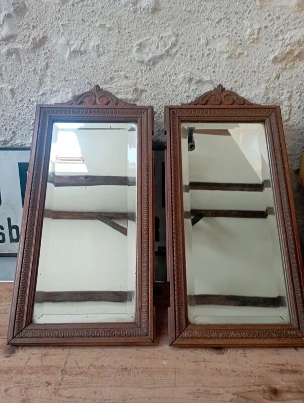 Set of two bevelled mirrors in moulded oak.