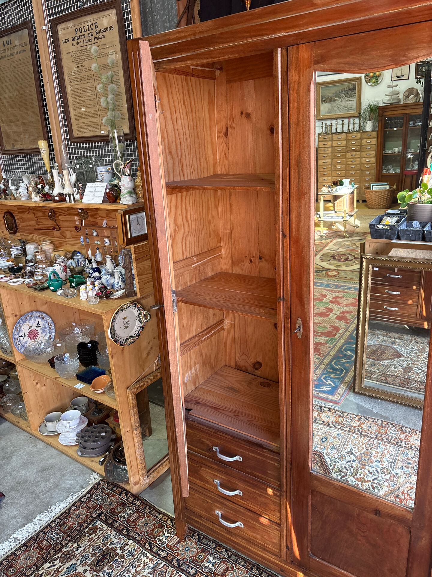 Antique Parisian wardrobe with mirror, hanging space and drawers.