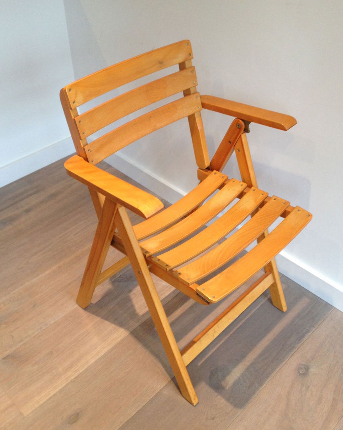 Pair of varnished wooden folding armchairs signed Clairitex.