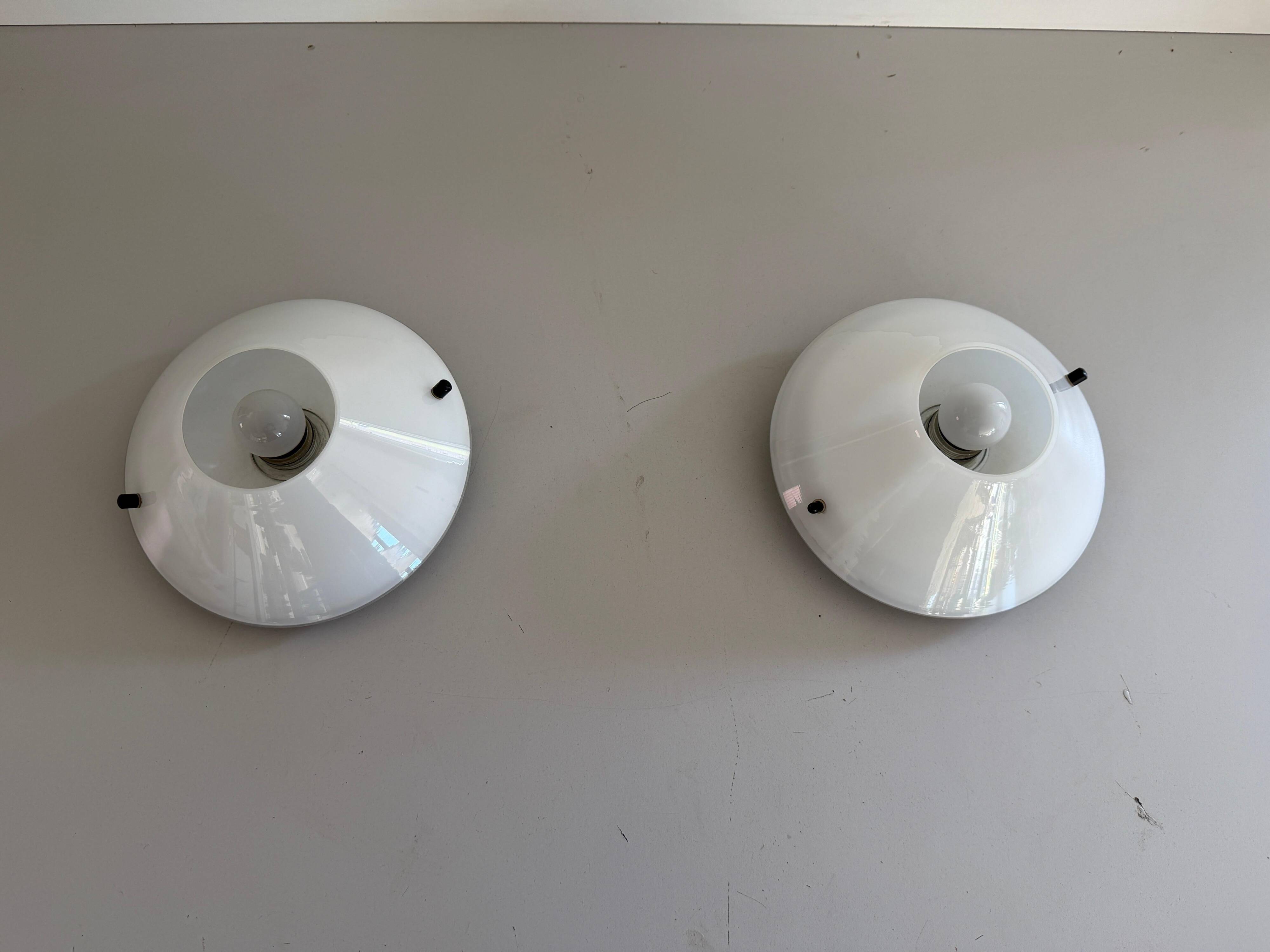 Pair of opal glass wall lights from the mid-century by Lamperti, 1960s, Italy.