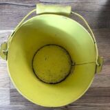 Small metal bucket with floral print on a yellow background