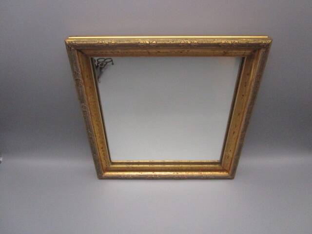 Small old mirror in wood and gilded stucco