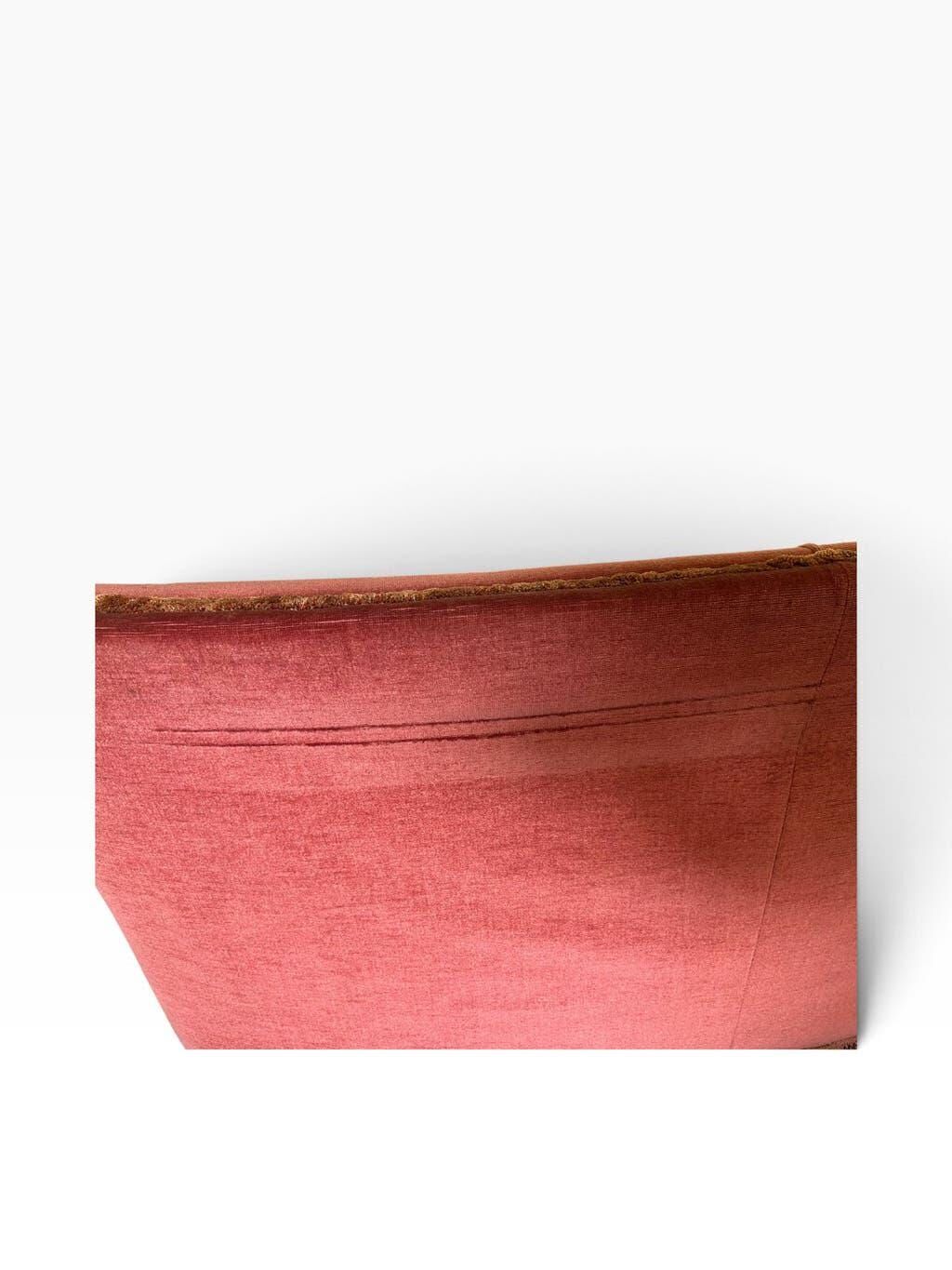 Vintage two-seater armchair in powder pink velvet with fringes.