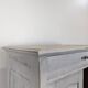 Small buffet with two doors and one drawer in white patinated wood.