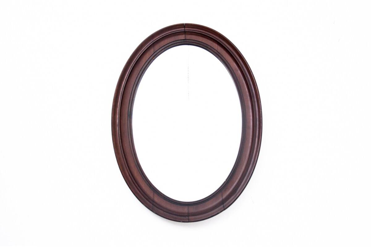 Oval mirror in a mahogany frame, Northern Europe, late 19th century.