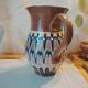 Pitcher with ethnic decorations