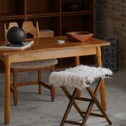 Folding stool, reupholstered in long-haired sheepskin, mid-century modern style, 1950s.