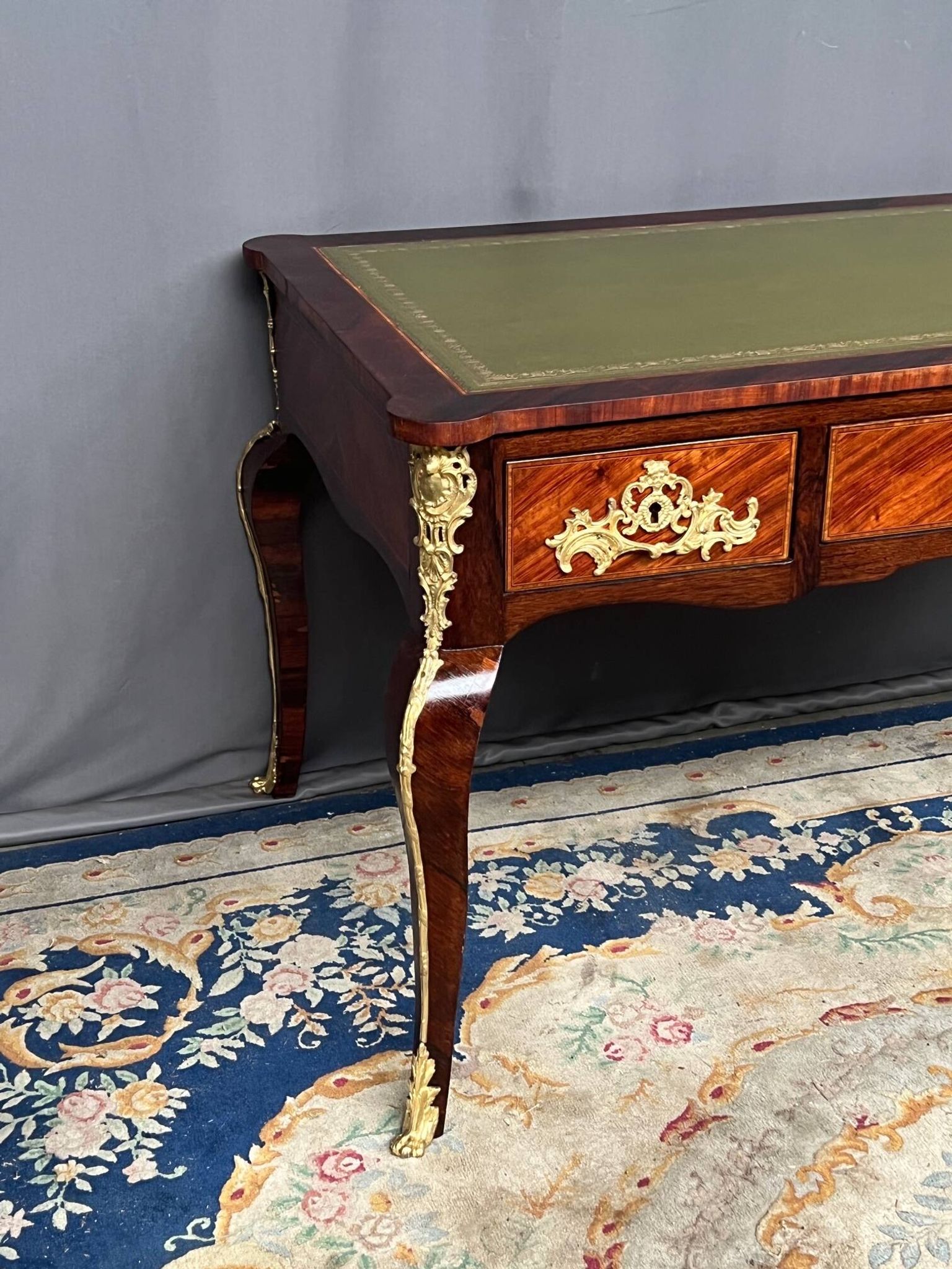 Louis XV style desk. Rosewood veneer, gilt bronze decoration, leather.