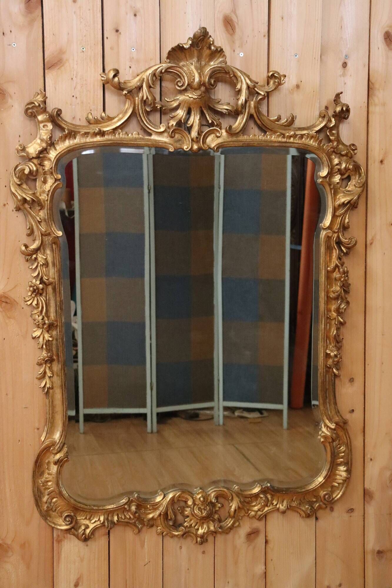 Golden wooden mirror in Louis XV style