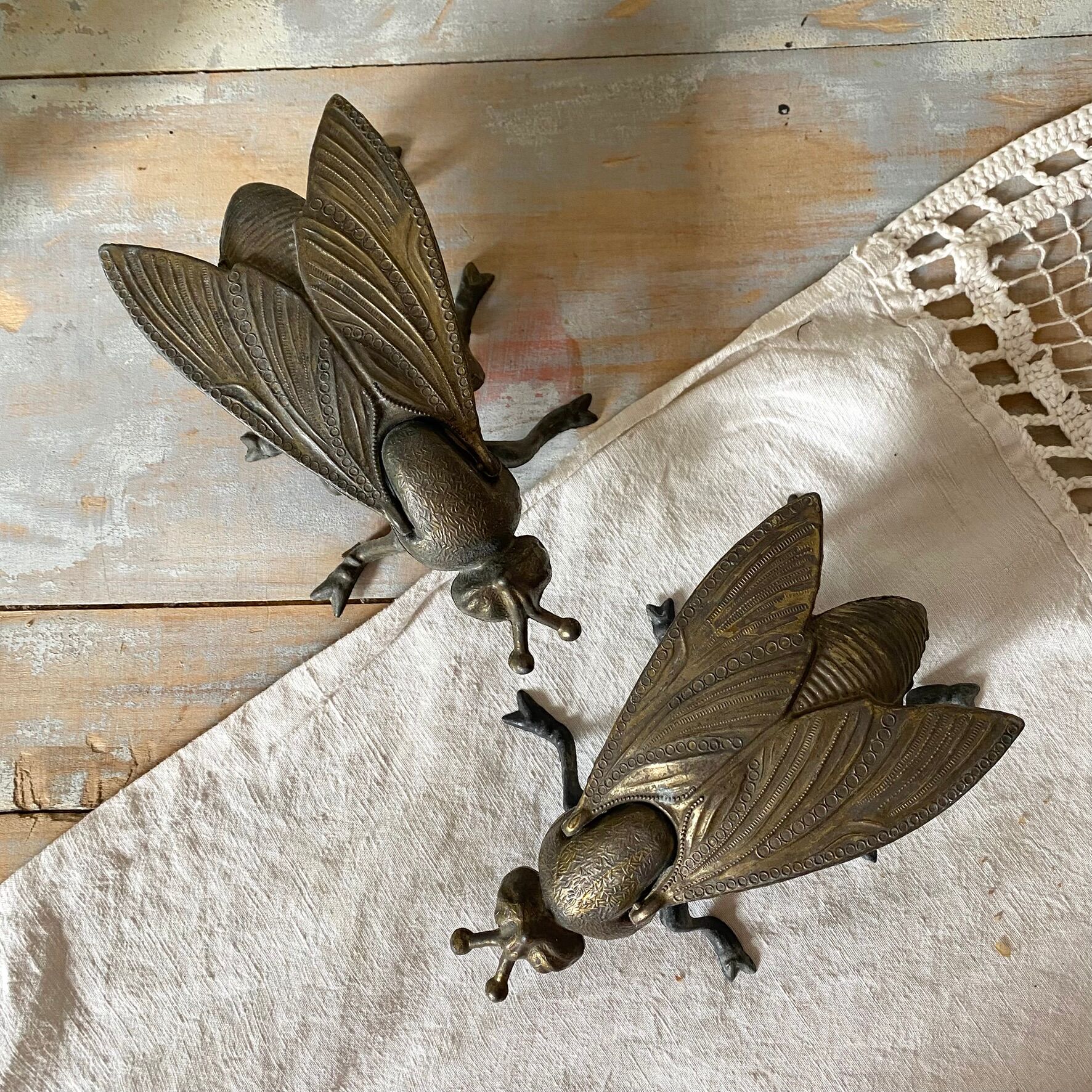 2 metal ashtrays with insect fly designs from the 1950s-60s.