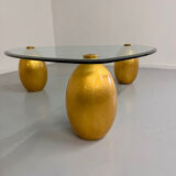 Vintage Italian design coffee table with a glass top and gold base, dating from the 1980s.