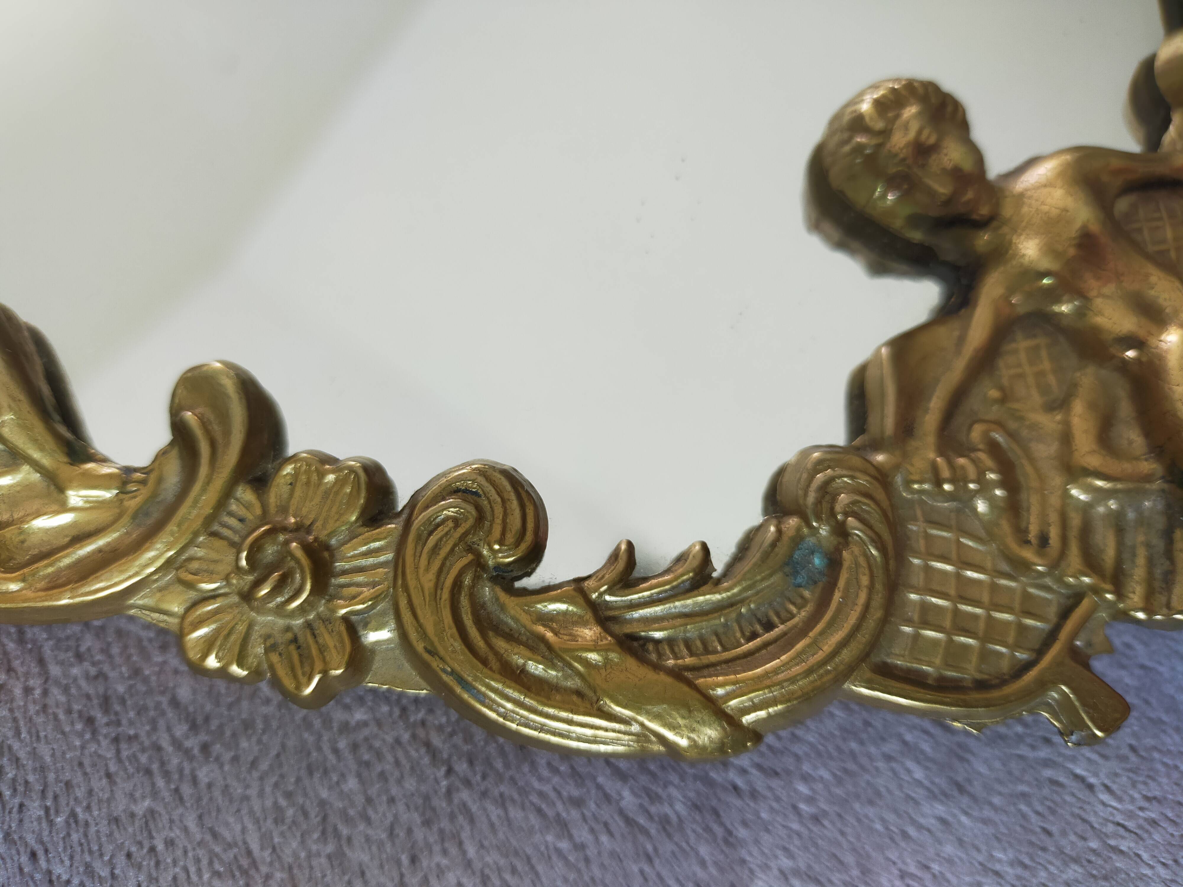 Gilded bronze mirror with angel ornament