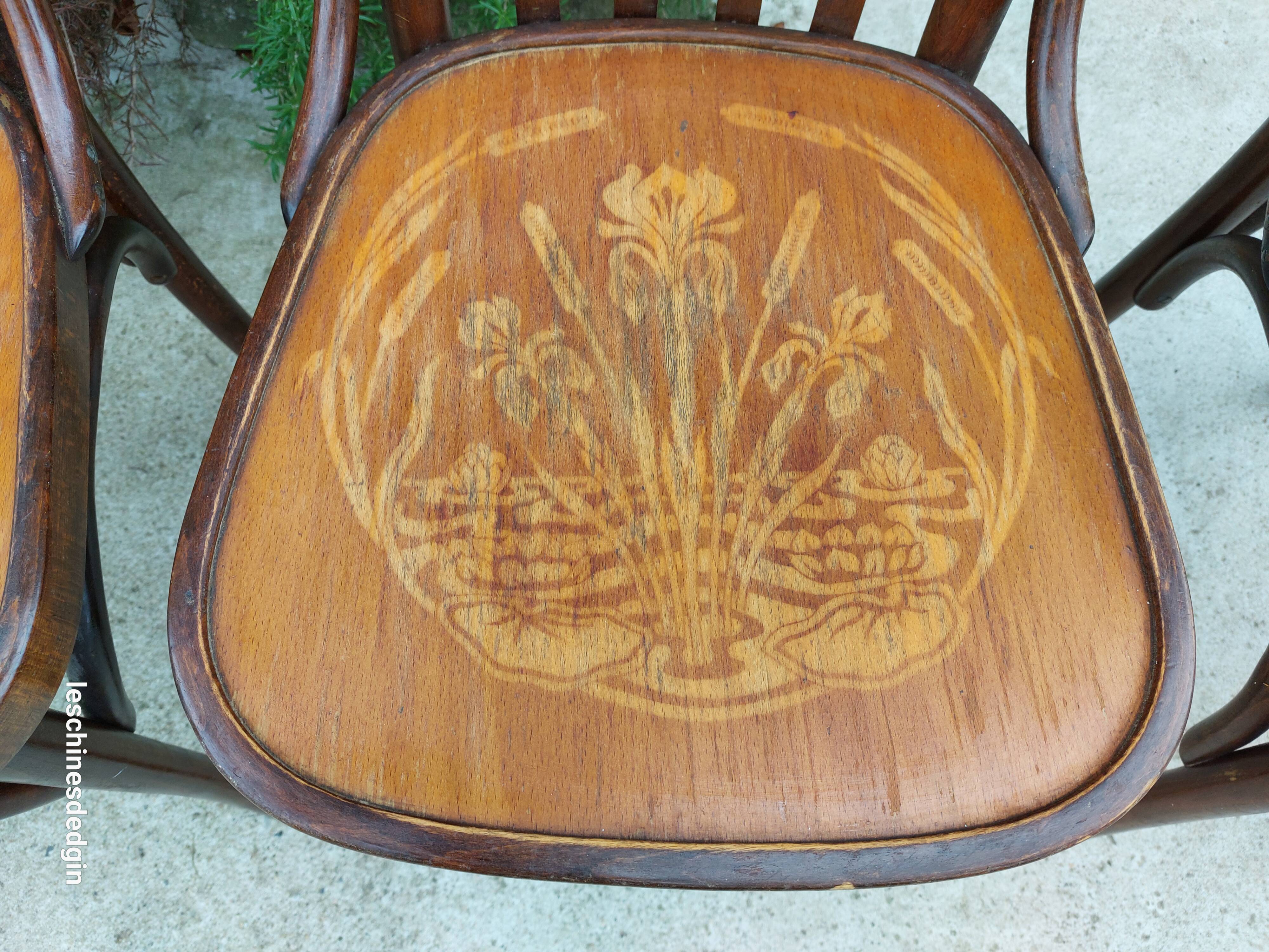4 bentwood bistro chairs with a pattern on the seat