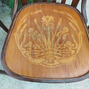 4 bentwood bistro chairs with a pattern on the seat