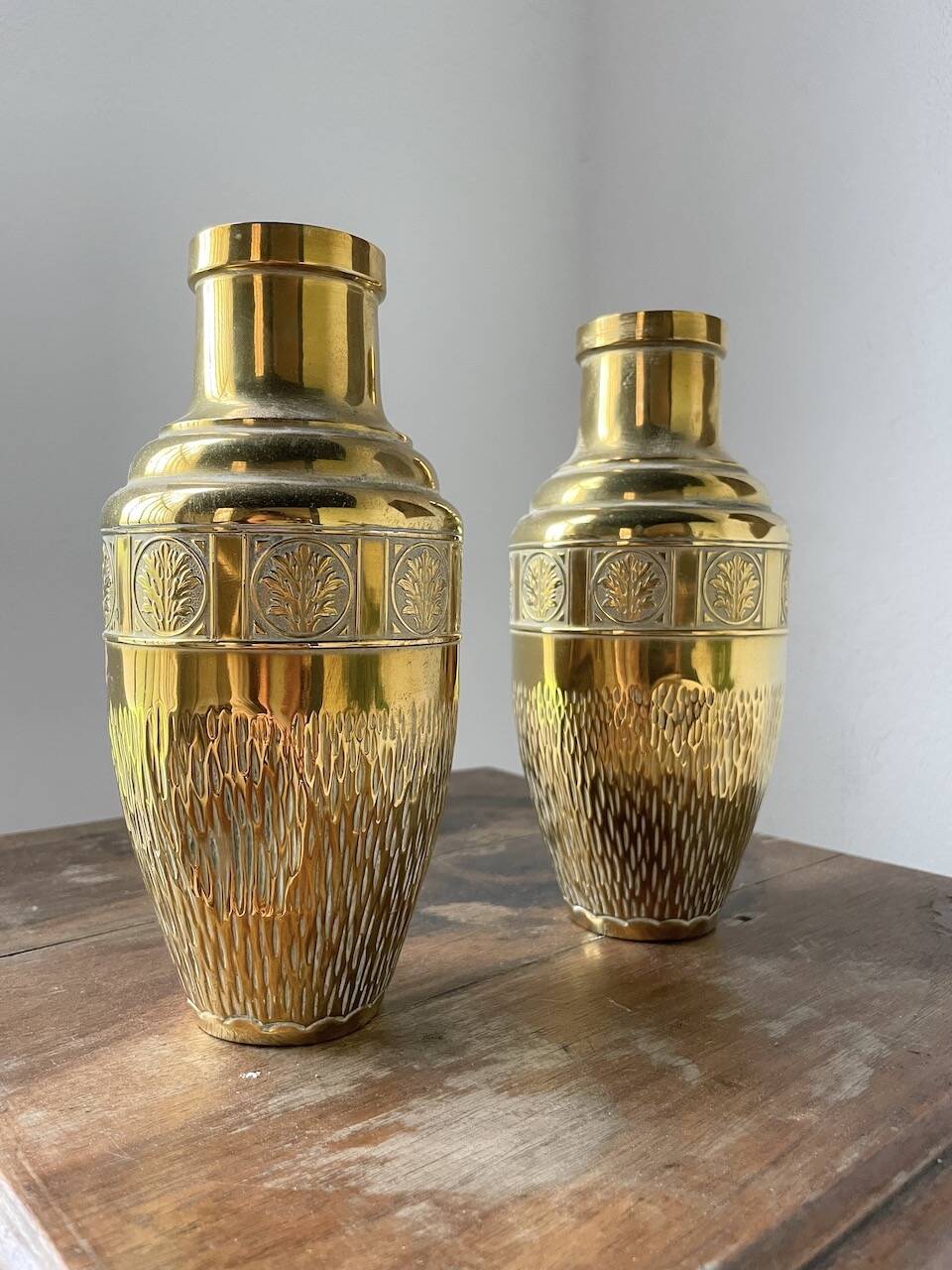 Duo of embossed brass vases