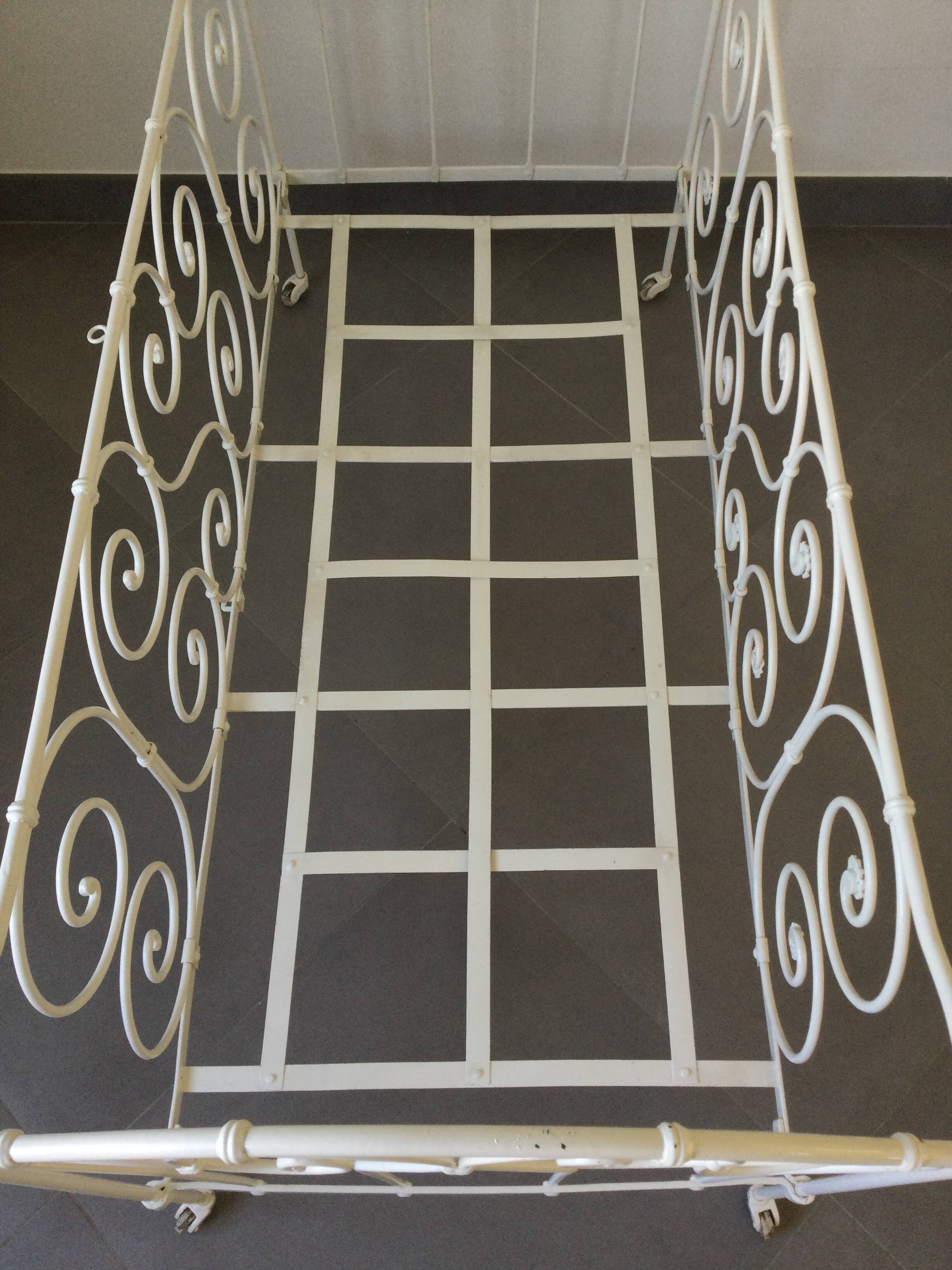 White wrought iron folding bed