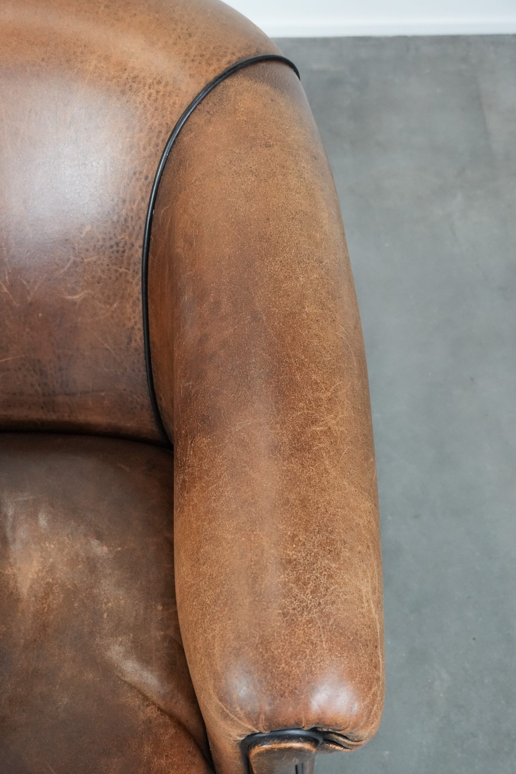 Sturdy vintage sheepskin club armchair with a beautiful patina