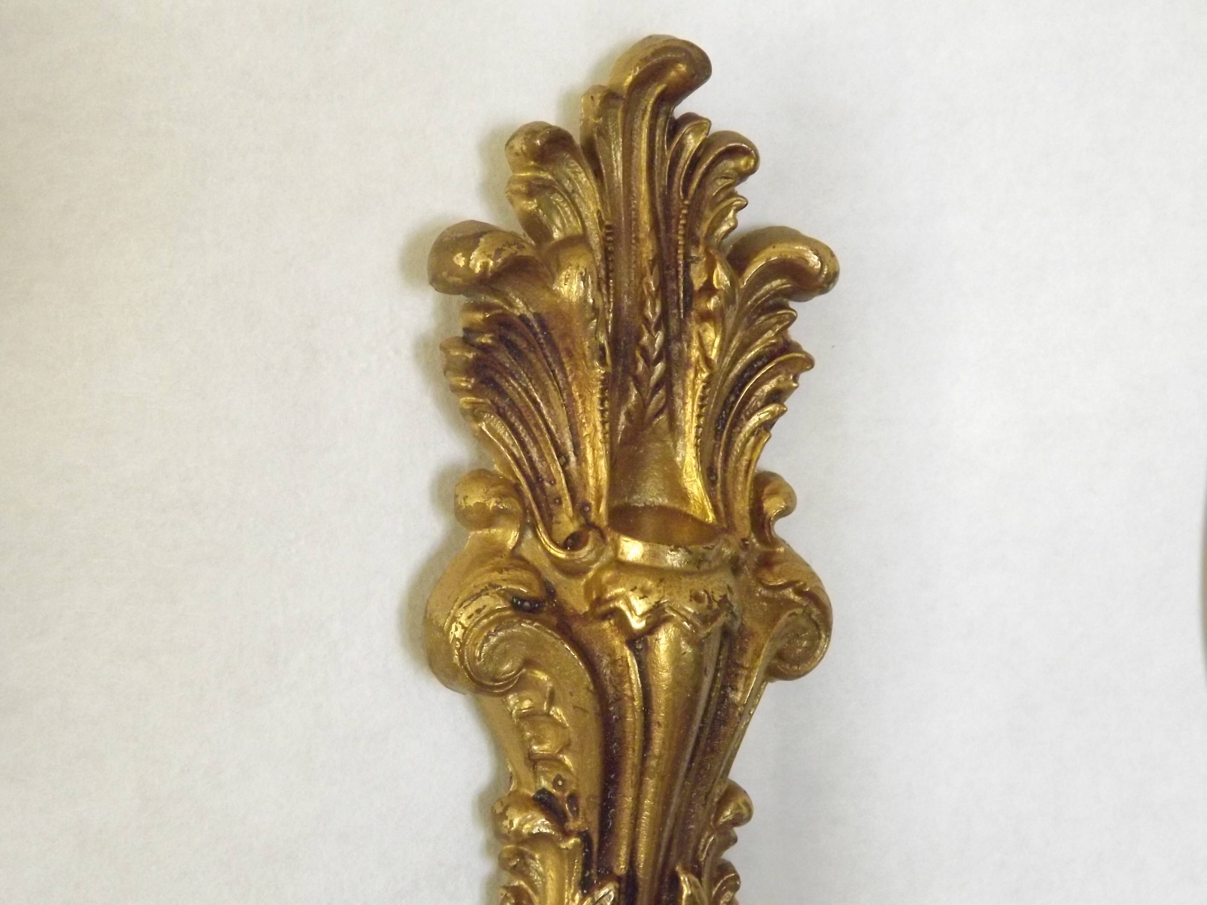 Pair of simple vintage French wall sconces in Art Nouveau bronze with leaf-shaped details.