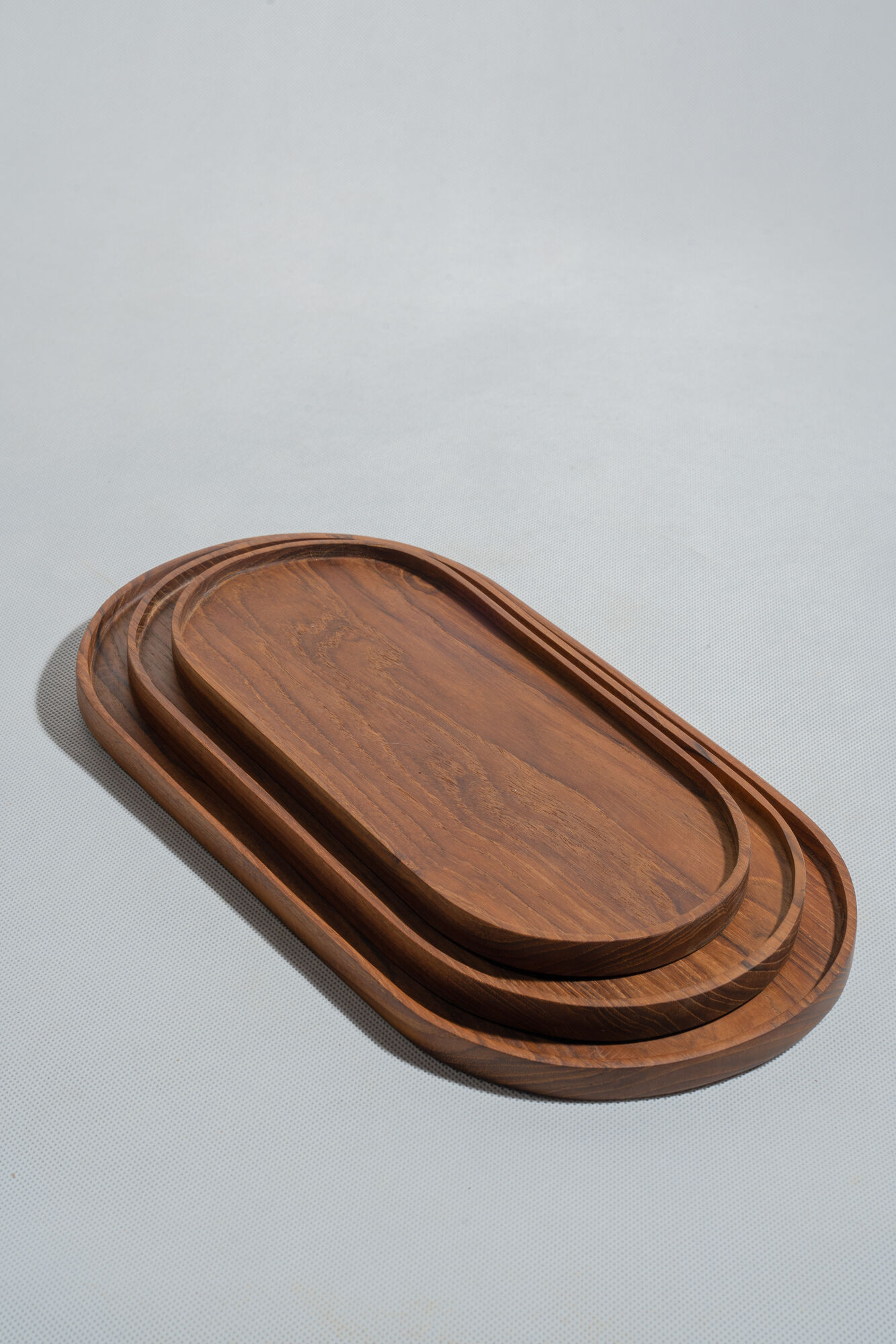 Trio of oval teak trays or cups