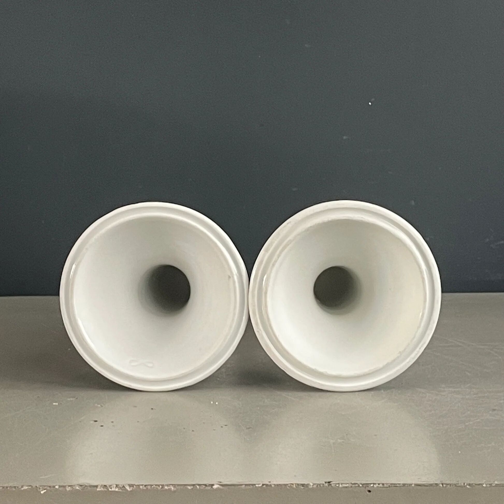 Pair of porcelain candlesticks with a gold pattern.