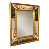 Large Venetian-style mirror with golden floral decoration.