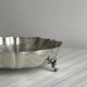 Silver-plated metal basket on rockwork feet