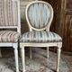 Pair of Louis XVI style chairs in painted wood and satin, classic elegance.
