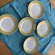 6 small plates with yellow borders and floral pattern gold antiques