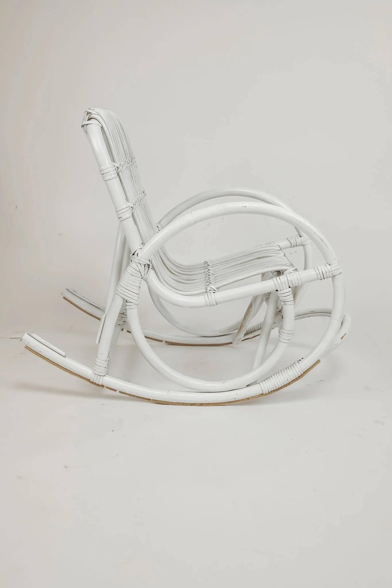 Vintage rocking chair for children in rattan/bamboo.