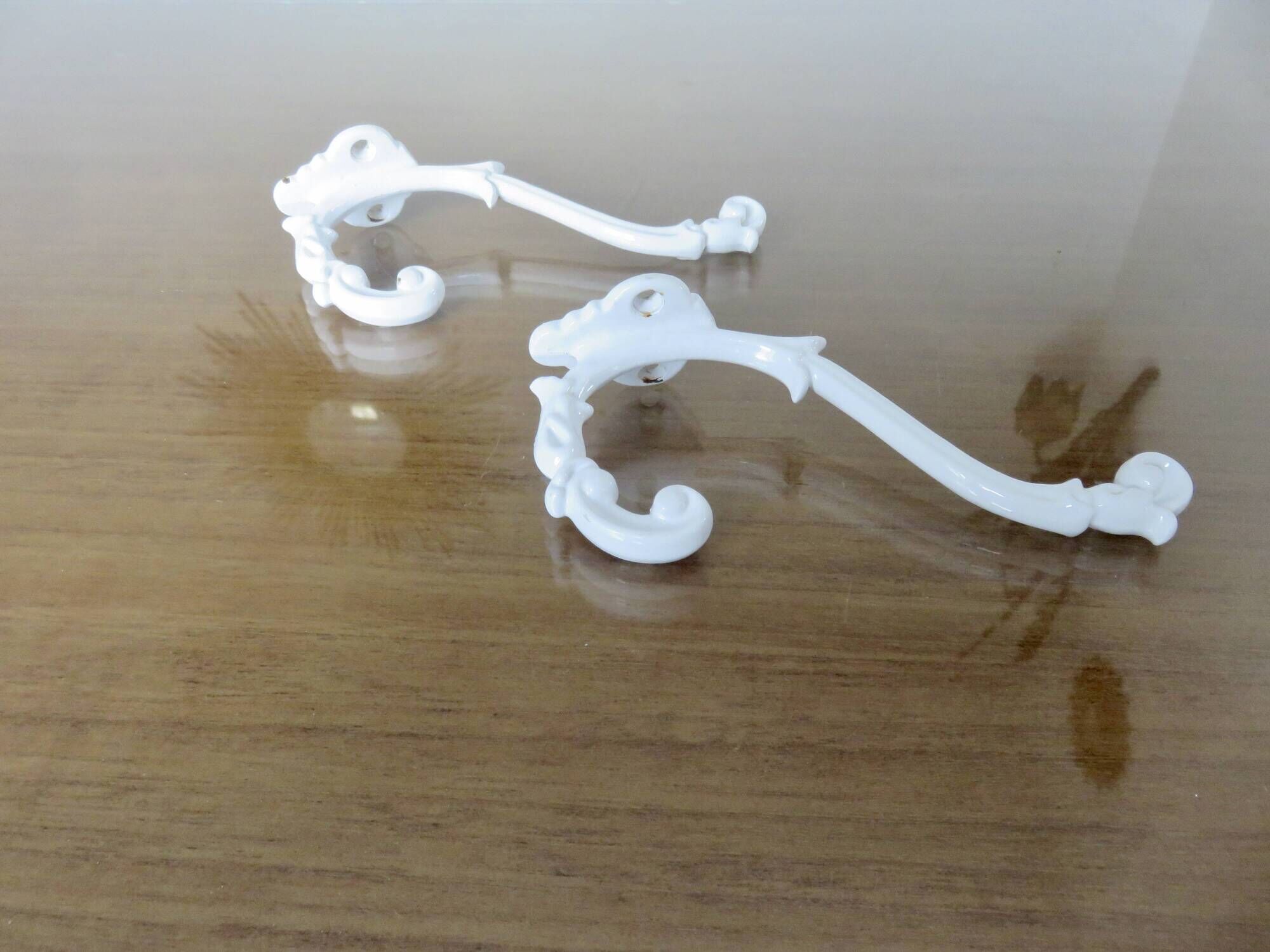 Pair of Art Deco white cast iron coat hooks from the 1930s and 1940s