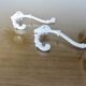 Pair of Art Deco white cast iron coat hooks from the 1930s and 1940s