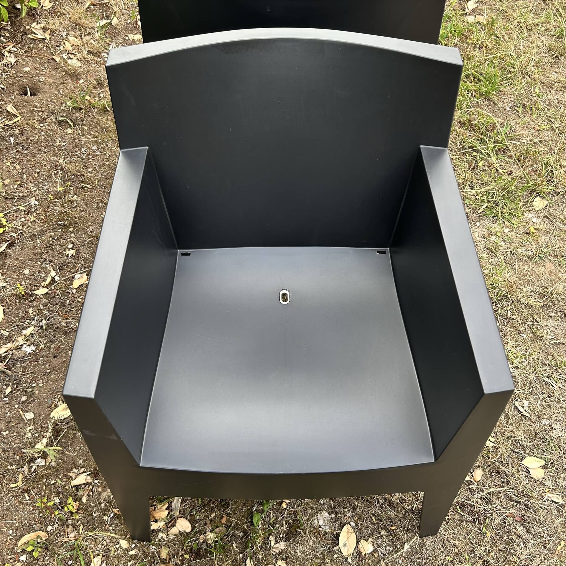 2 black Toy chairs designed by Starck