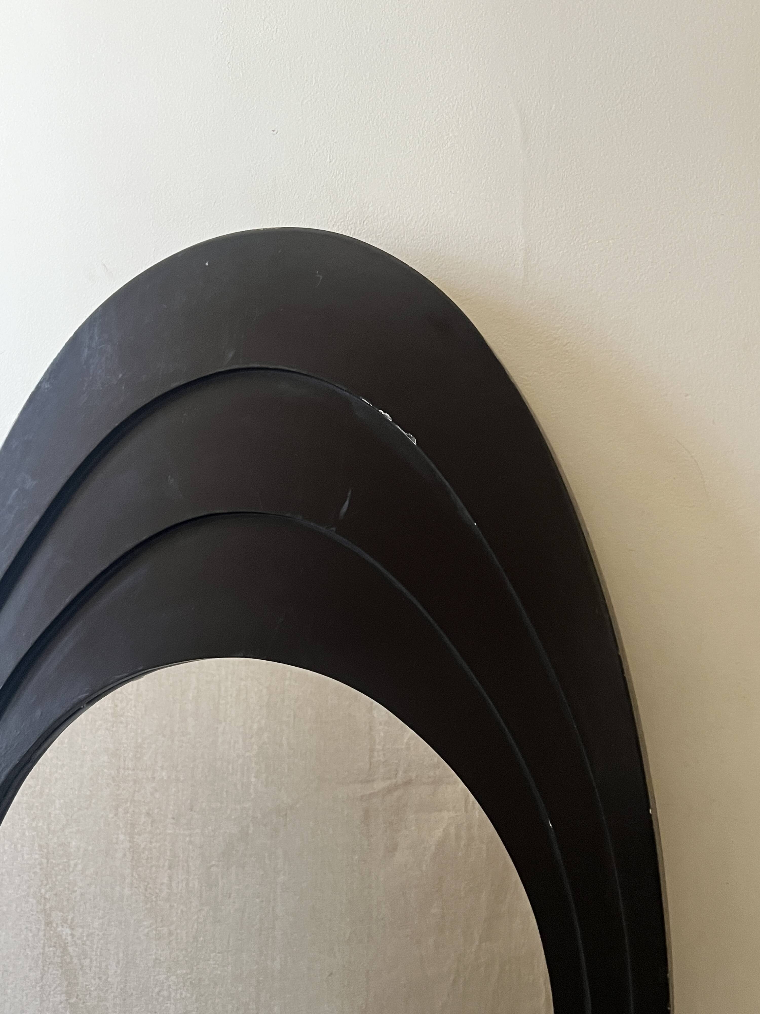 Large oval Italian mirror, modernist, space age design from the 1970s.