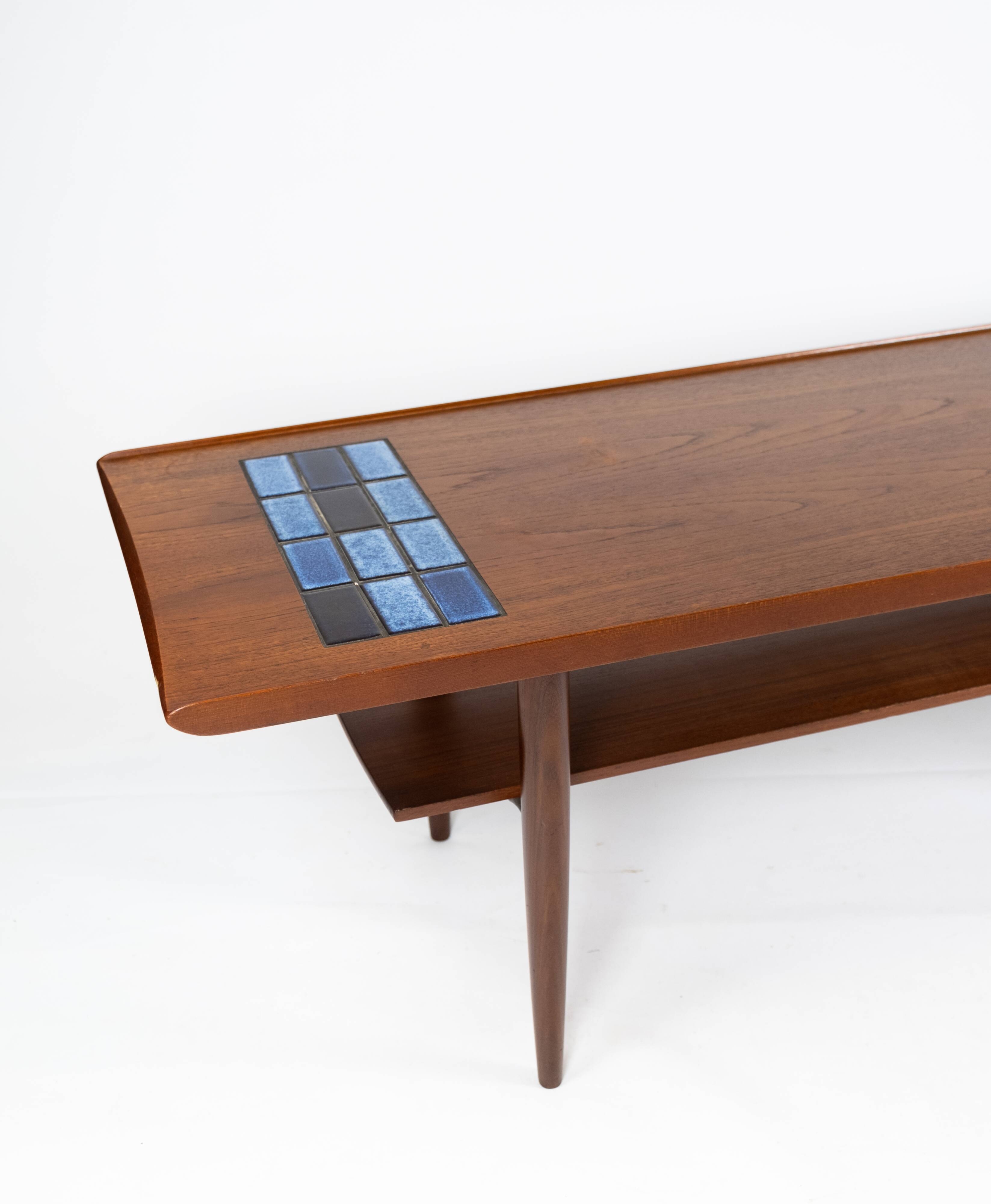 Coffee table in teak with blue tiles of danish design from the 1960s.