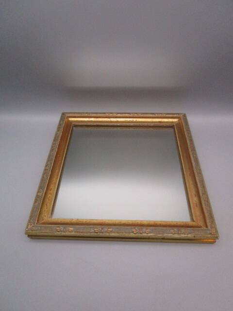 Small old mirror in wood and gilded stucco