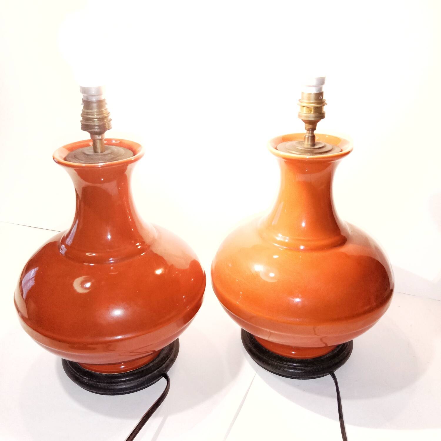 Pair of ceramic lamp bases in the shape of orange gourds.