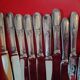 11 cheese knives in silver-filled metal and stainless steel.