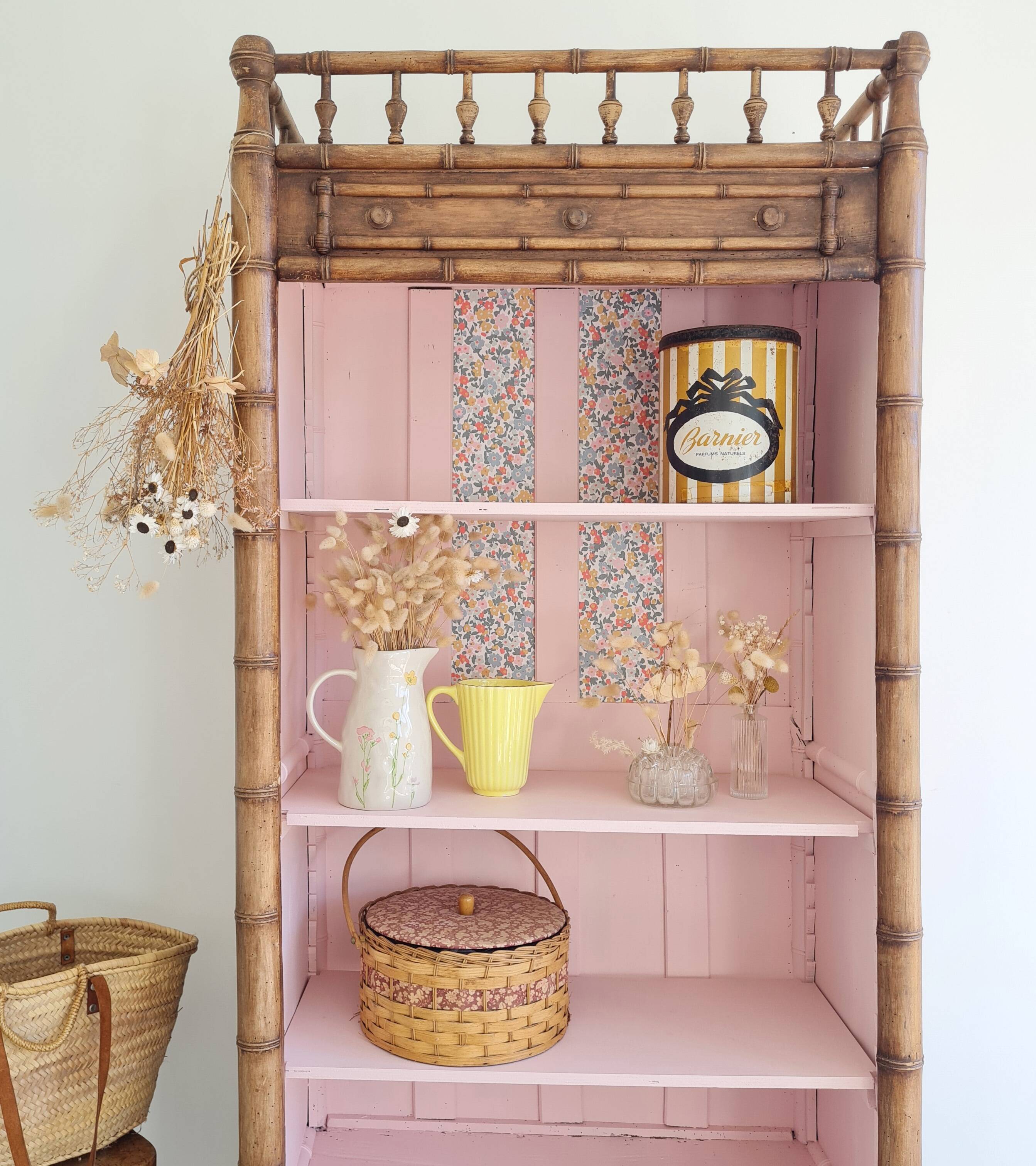Library, old wooden cabinet imitating bamboo painted in pink