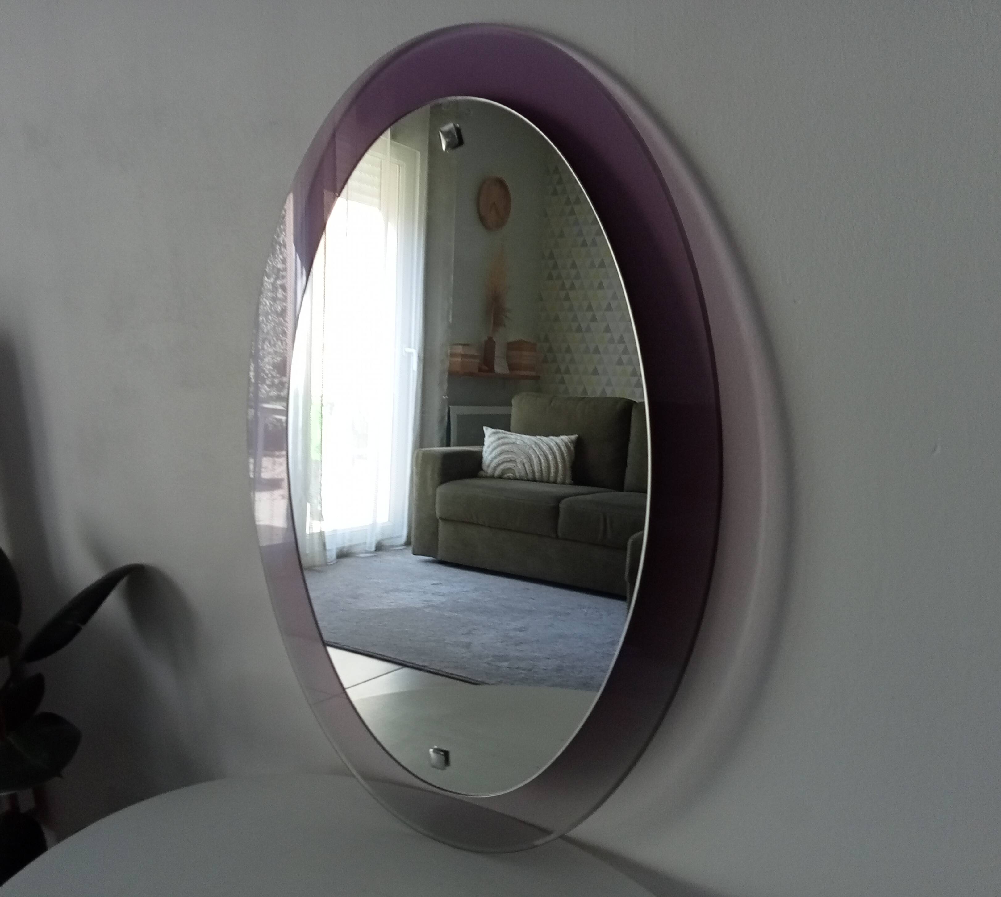 Vintage oval plexiglass mirror from the 70s by Harvey Guzzini