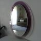 Vintage oval plexiglass mirror from the 70s by Harvey Guzzini