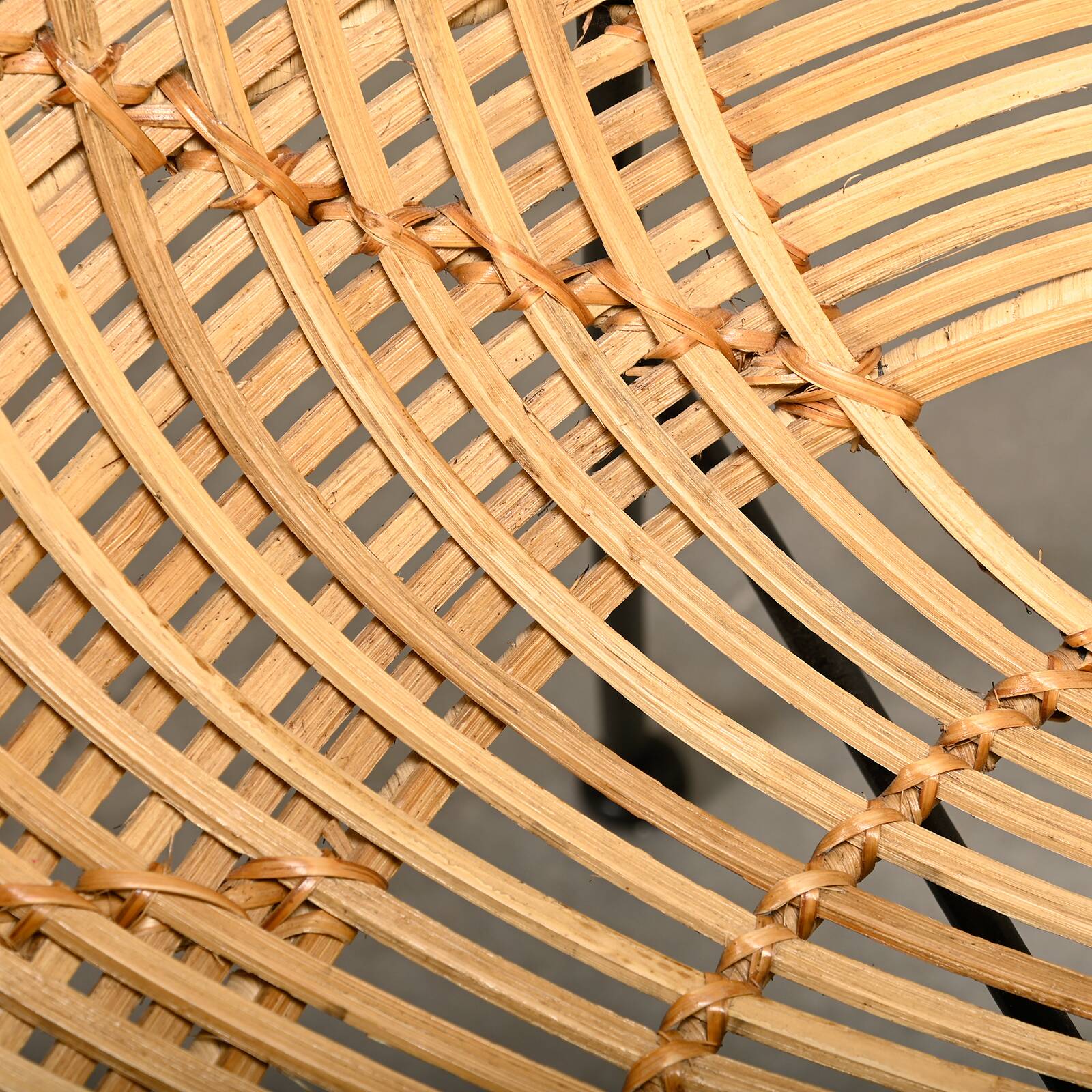 Round rattan lounge chair with black metal frame