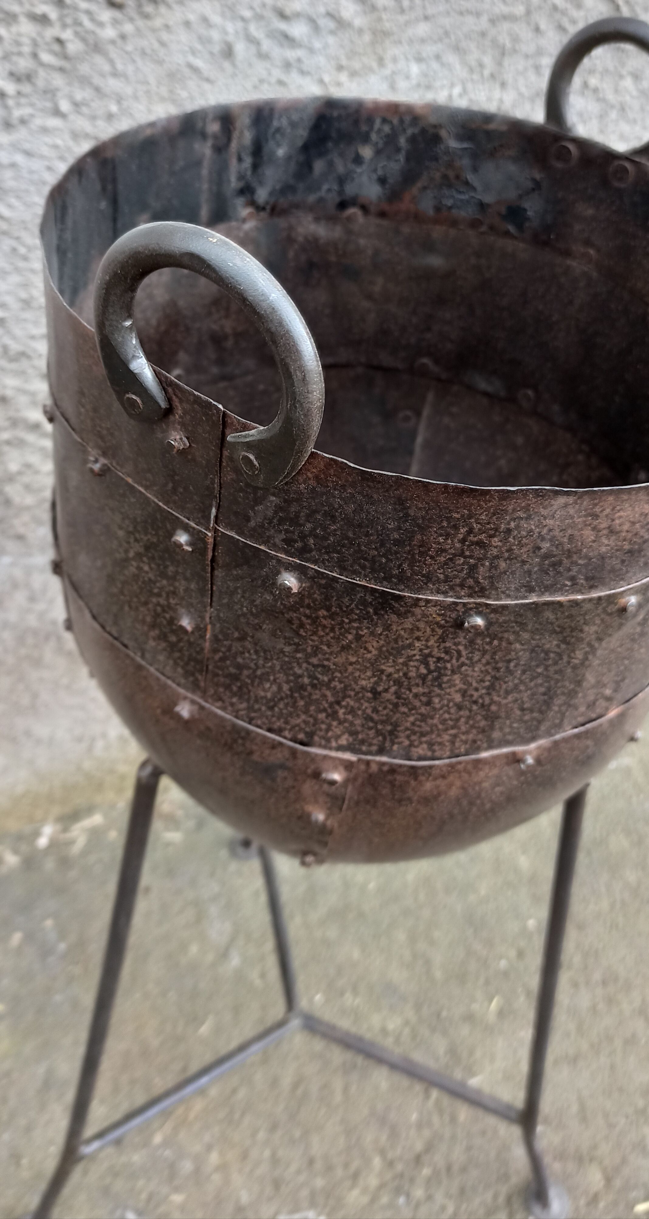 Old metal pot on foot