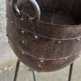 Old metal pot on foot