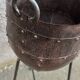 Old metal pot on foot