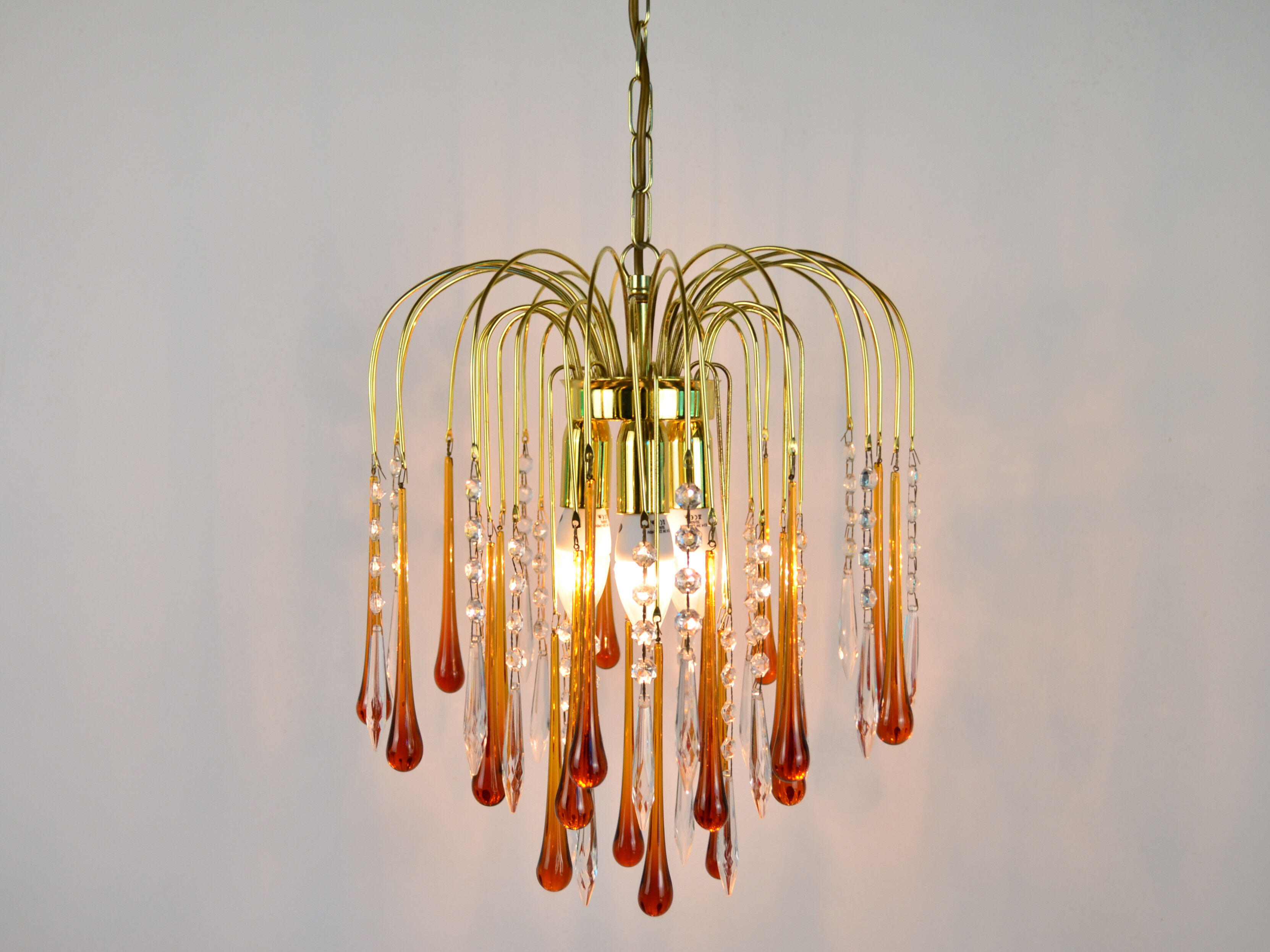 A pair of Mid Century 70's waterfall chandeliers. Murano glass amber drops. Paolo Venini style.