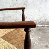 Dark brown solid wood Arts & Crafts armchair with natural rush seat and high back